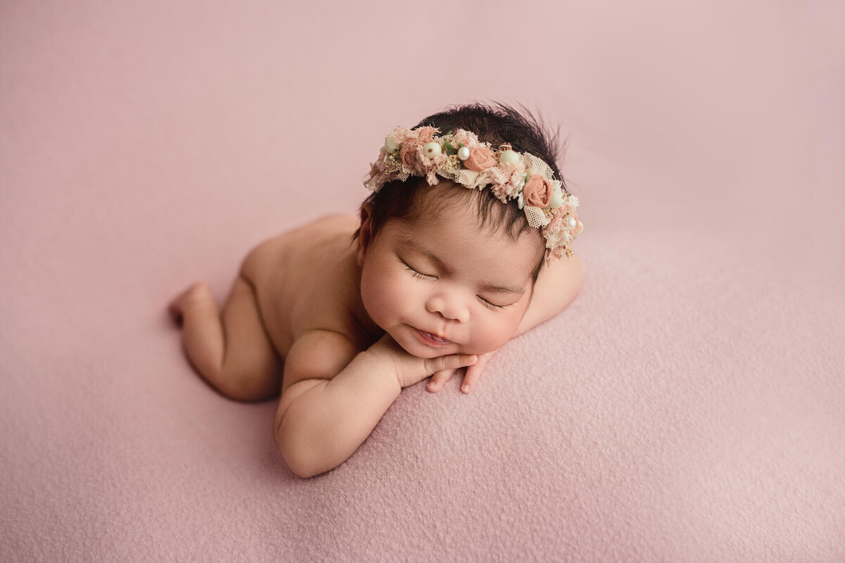 baby girl sleeping with head on hands during hamilton newborn photoshoot