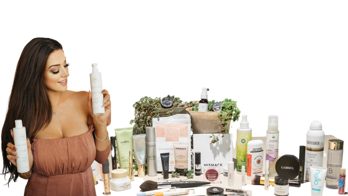 Cassandra posing with tbale of beauty products, transparent background