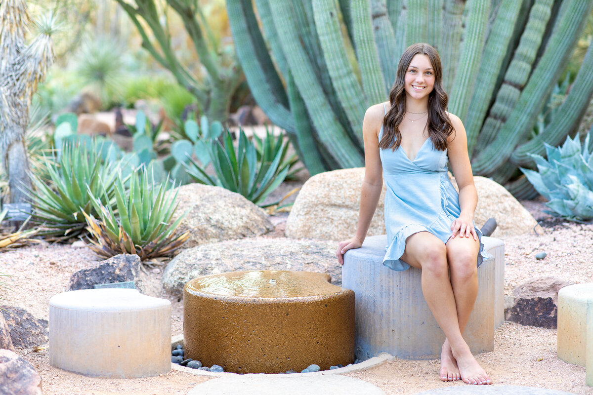 Senior girl sitting near cactus Popago Park AZ