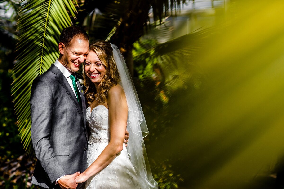 A couple laughs together during a Garfield Park Conservatory wedding.