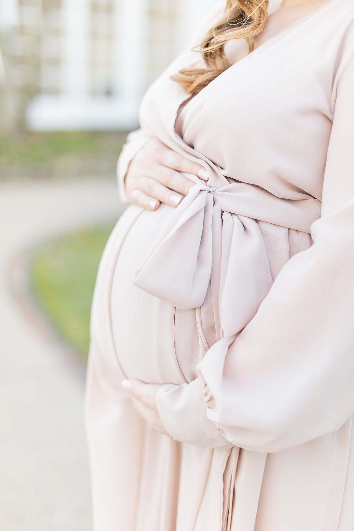 Pregnant mom holding baby bump in Carlsbad.