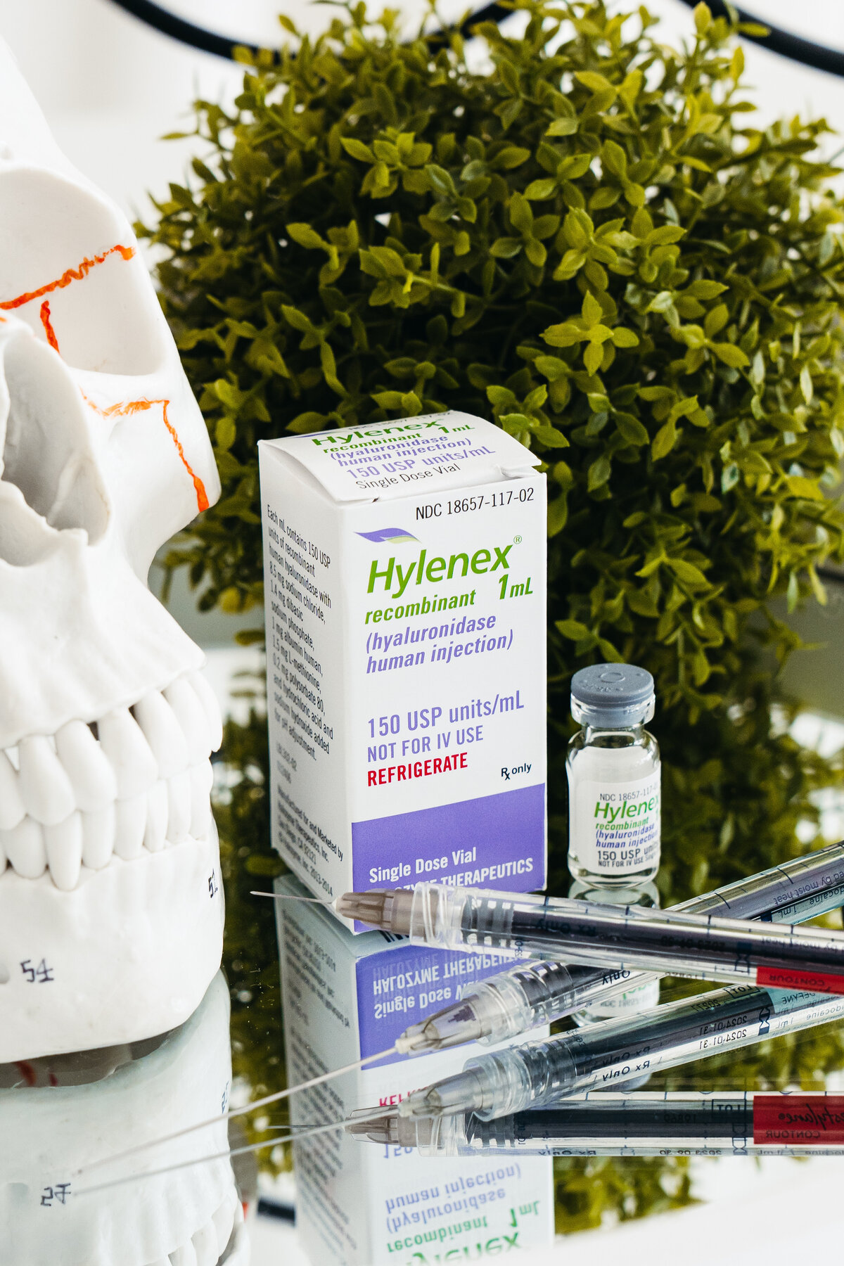 Hydrinity Accelerated Skin Science product line with metallic caps displayed on branded riser at Maxwell Aesthetics in Salem, Oregon