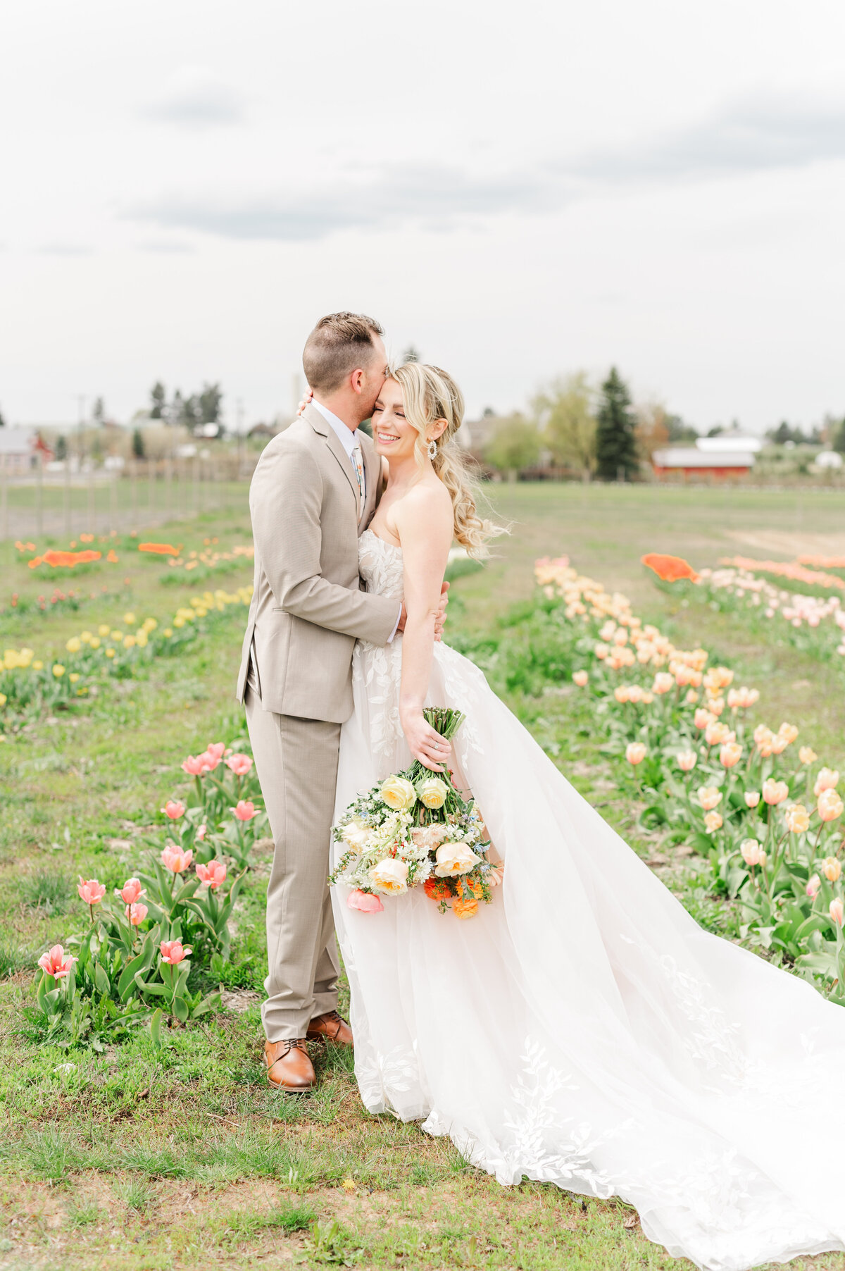bride and groom share a moment in a tulip field the farmhouse at greenbluff in spokane washington