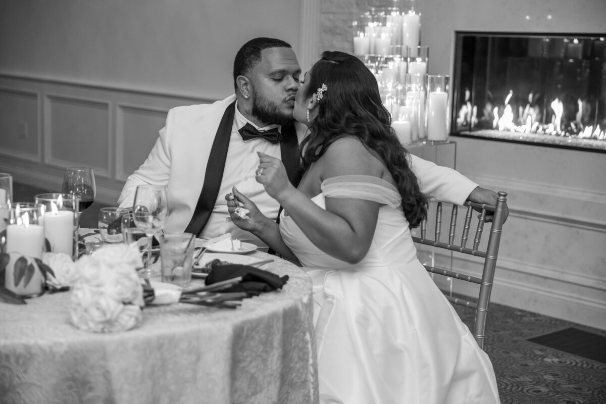 Bride and groom kissing at the table