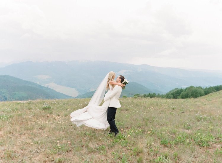 A happy just-married couple on top of a mountain in Colorado