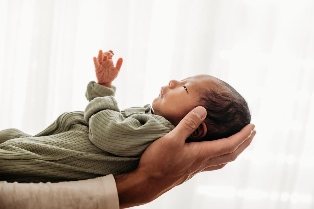 profile shot of a baby against a white wall