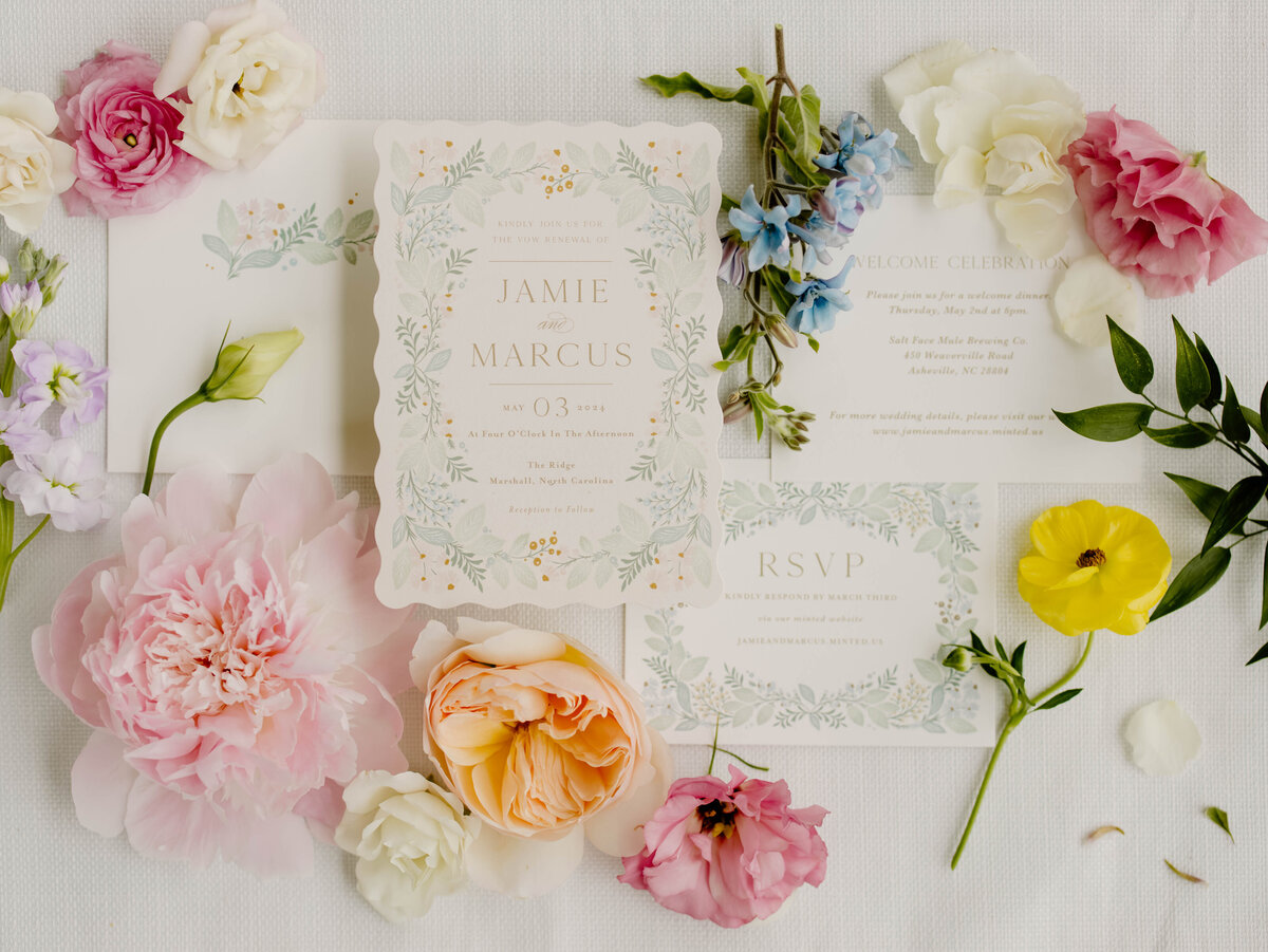 Wedding invitation flatlay with colorful florals North Carolina wedding ceremony with colorful florals designed by Abby Grace Florals at NC wedding