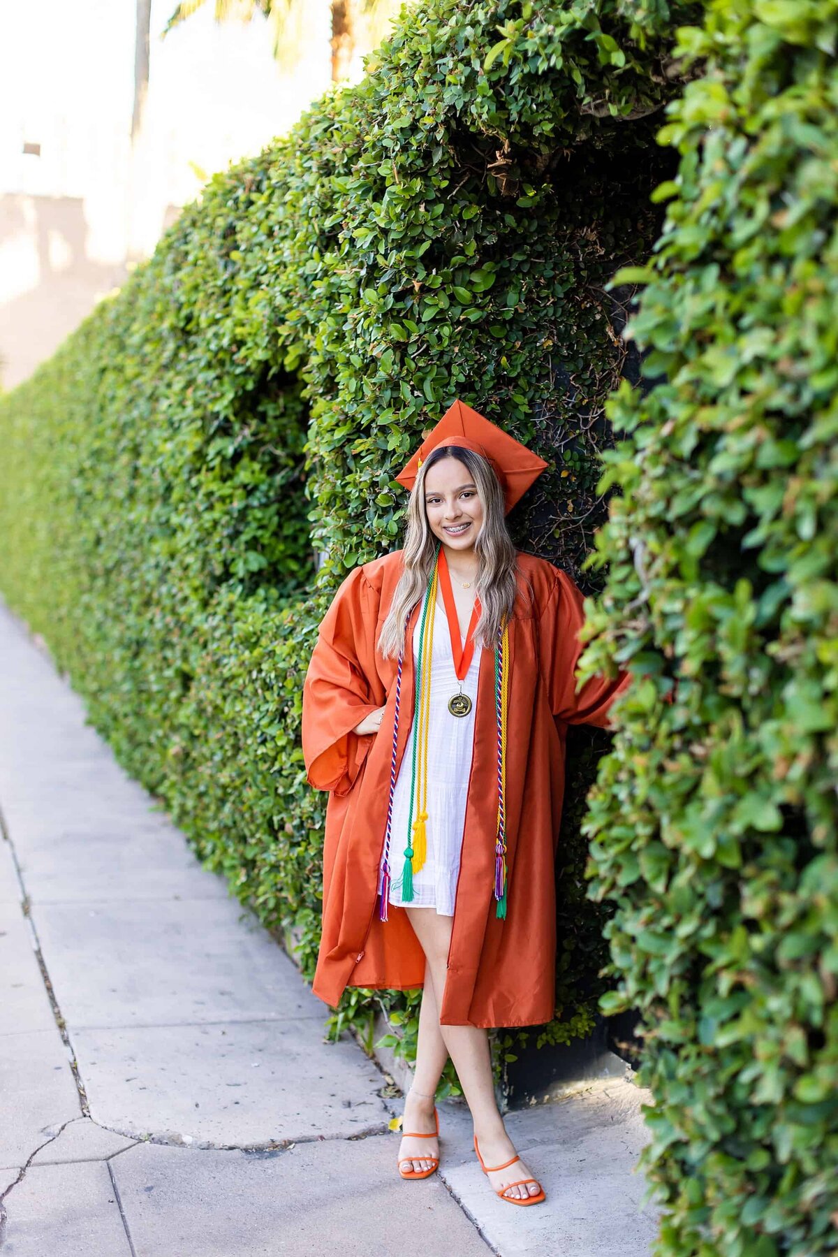 Senior in orange cap and gown