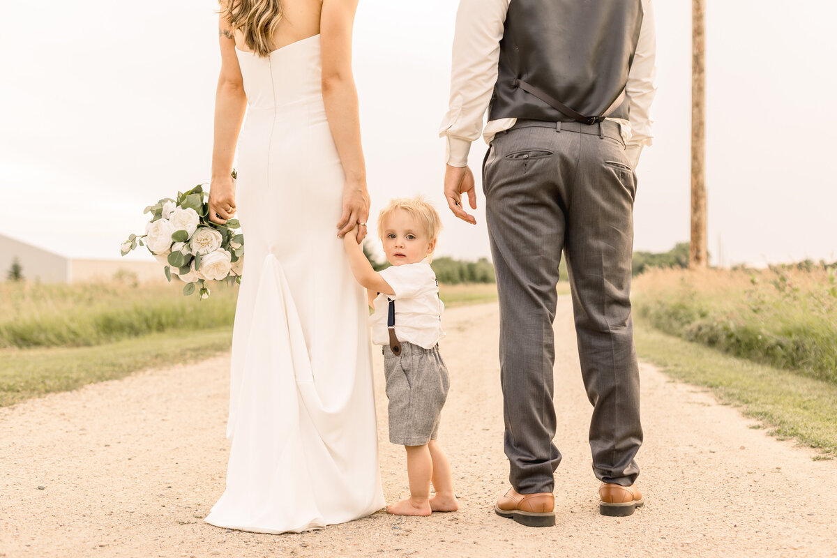 Bride and groom with their son on the wedding day