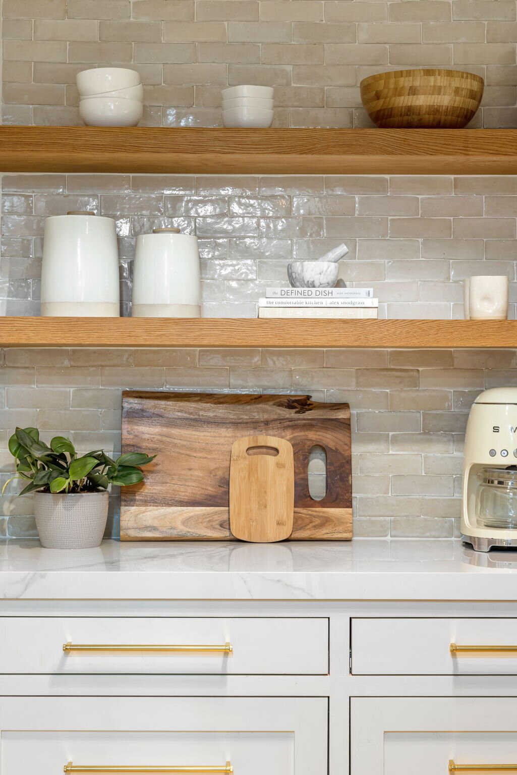 Details show of kitchen with cream tiles and floating wooden shelves