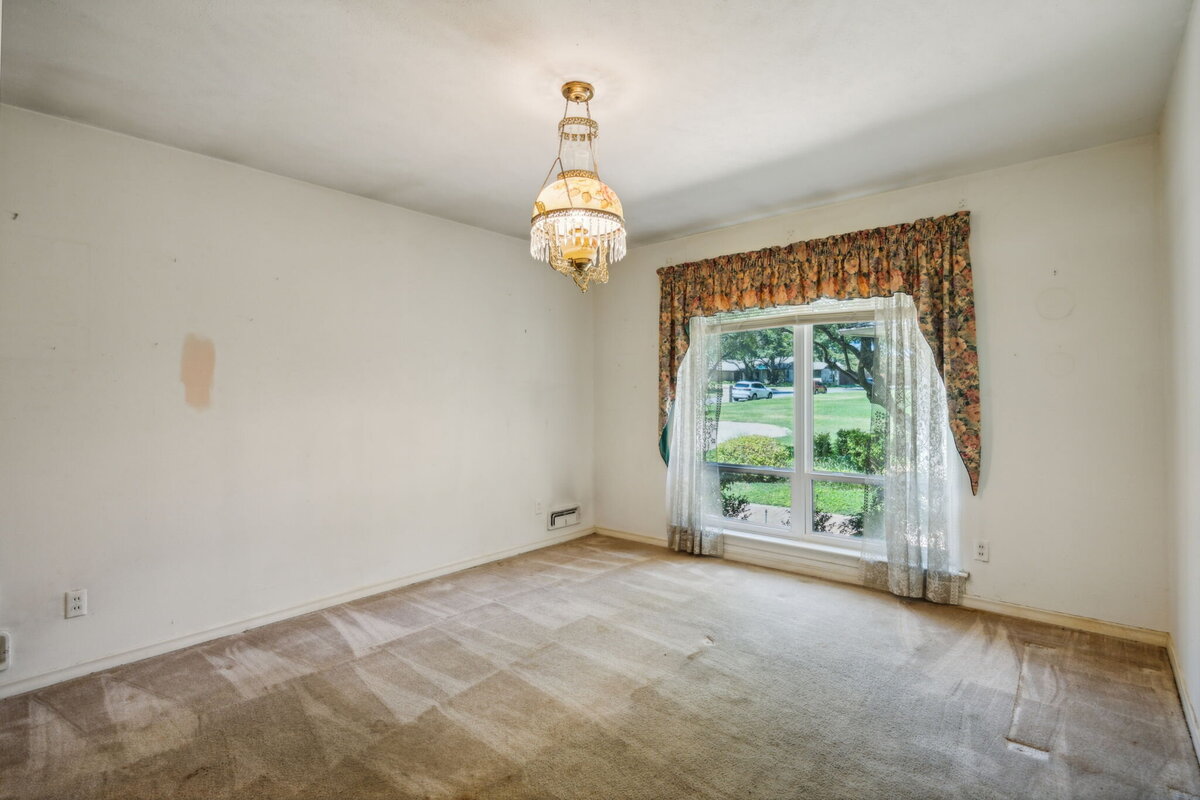 14214_edgecrest_dr_dallas_tx_front_bedroom_-large_window_with_front_yard_view_and_charming_vintage_light_fixture-_haven_realty_group