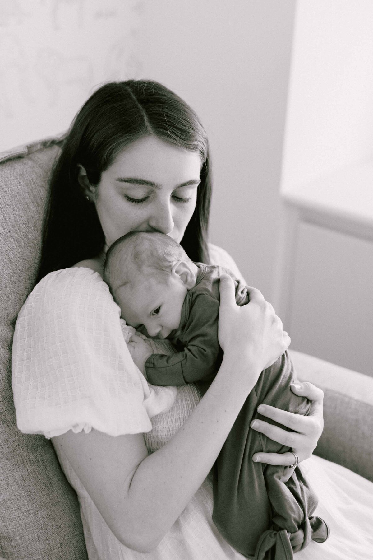 mom kissing her baby's head