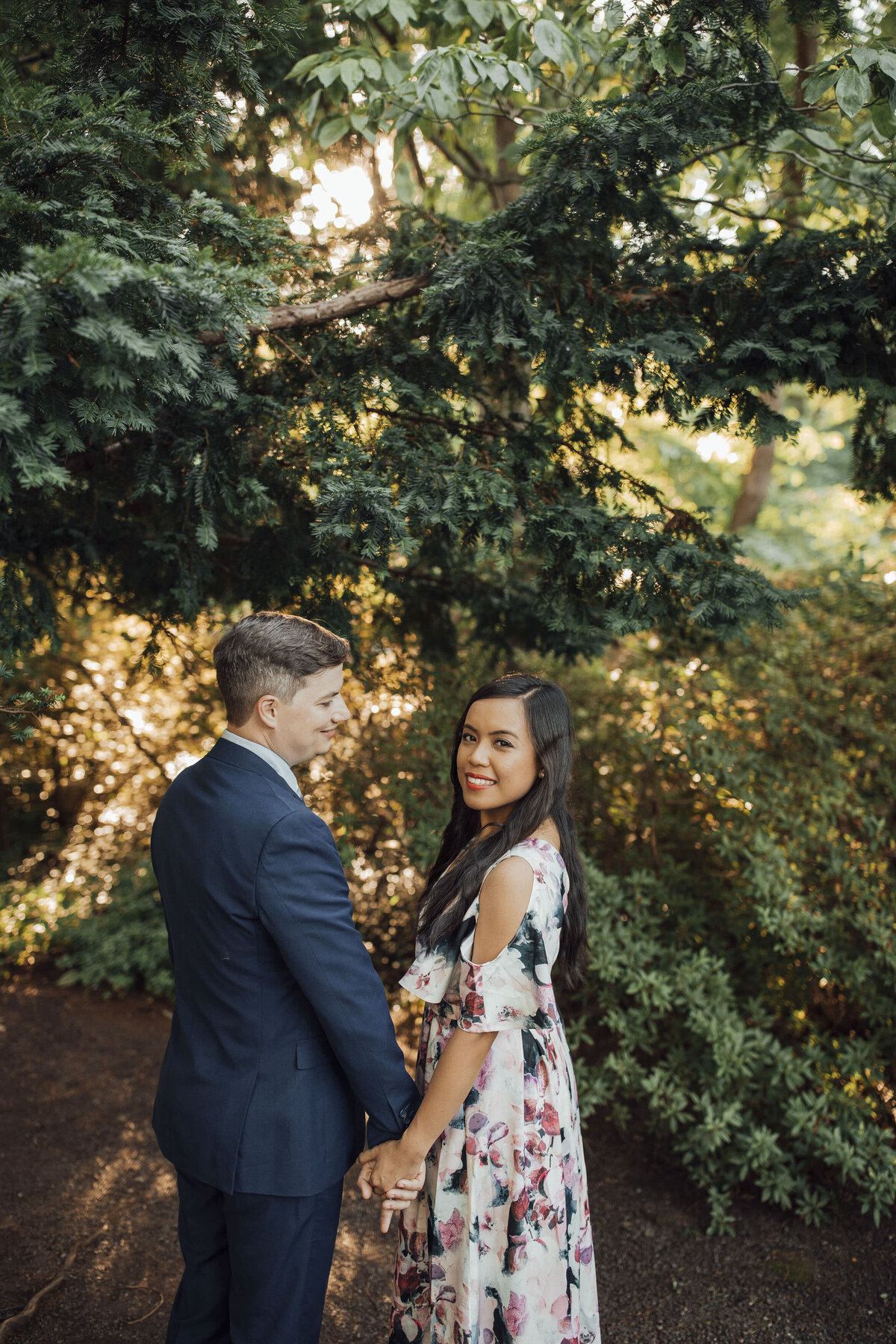 Couple holding hands during summer pre-wedding session at Sayen House and Gardens in Hamilton Township New Jersey