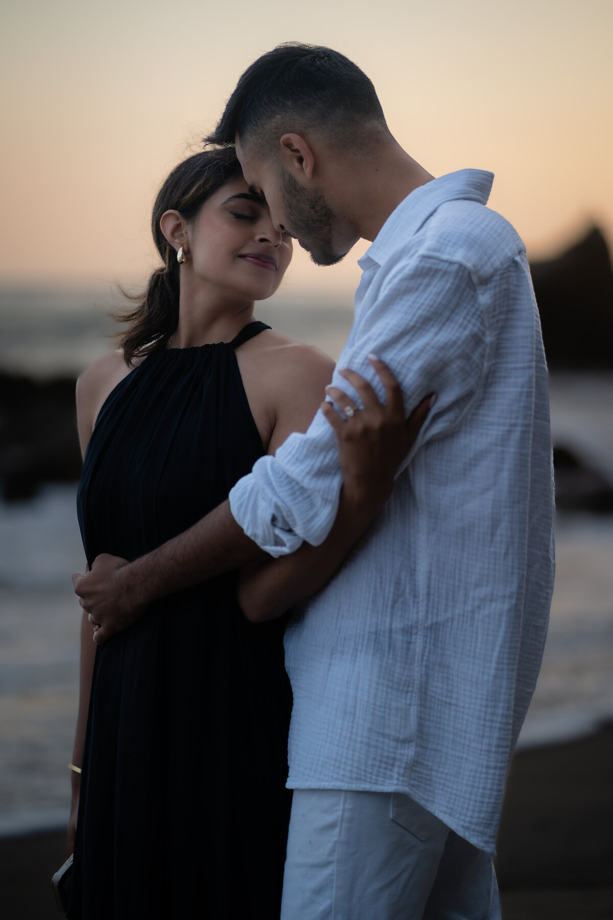 Indian couple eloping at El Matador State Beach in Malibu during low-tide sunset and rocky beach.