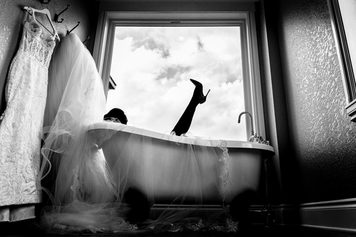 bride-in-tub-kicks-up-leg-austin-wedding-photographer-john-winters-photography-1-1536x1024