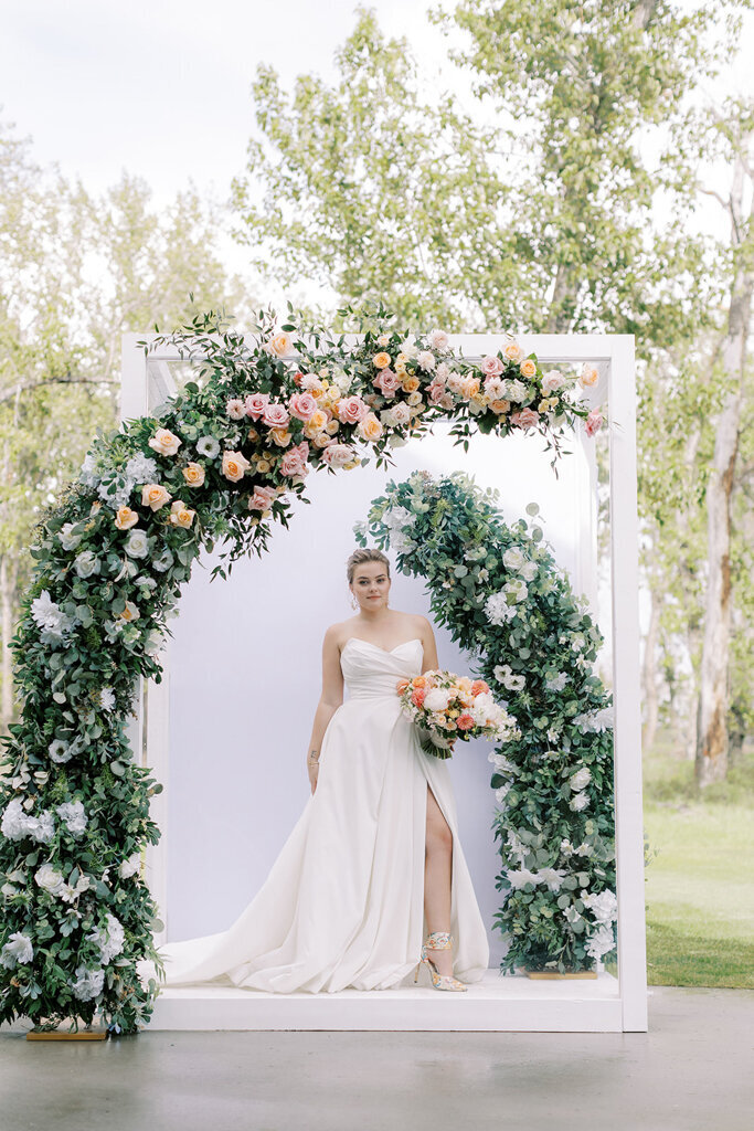 Bride looking in mirror at Sugar Pine Island, a romantic wedding venue in Foothills, Alberta, featured on the Brontë Bride Vendor Guide.