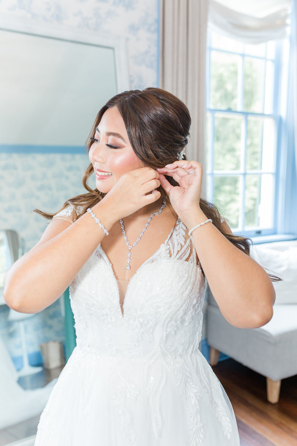 Bride fixing her earrings before the wedding
