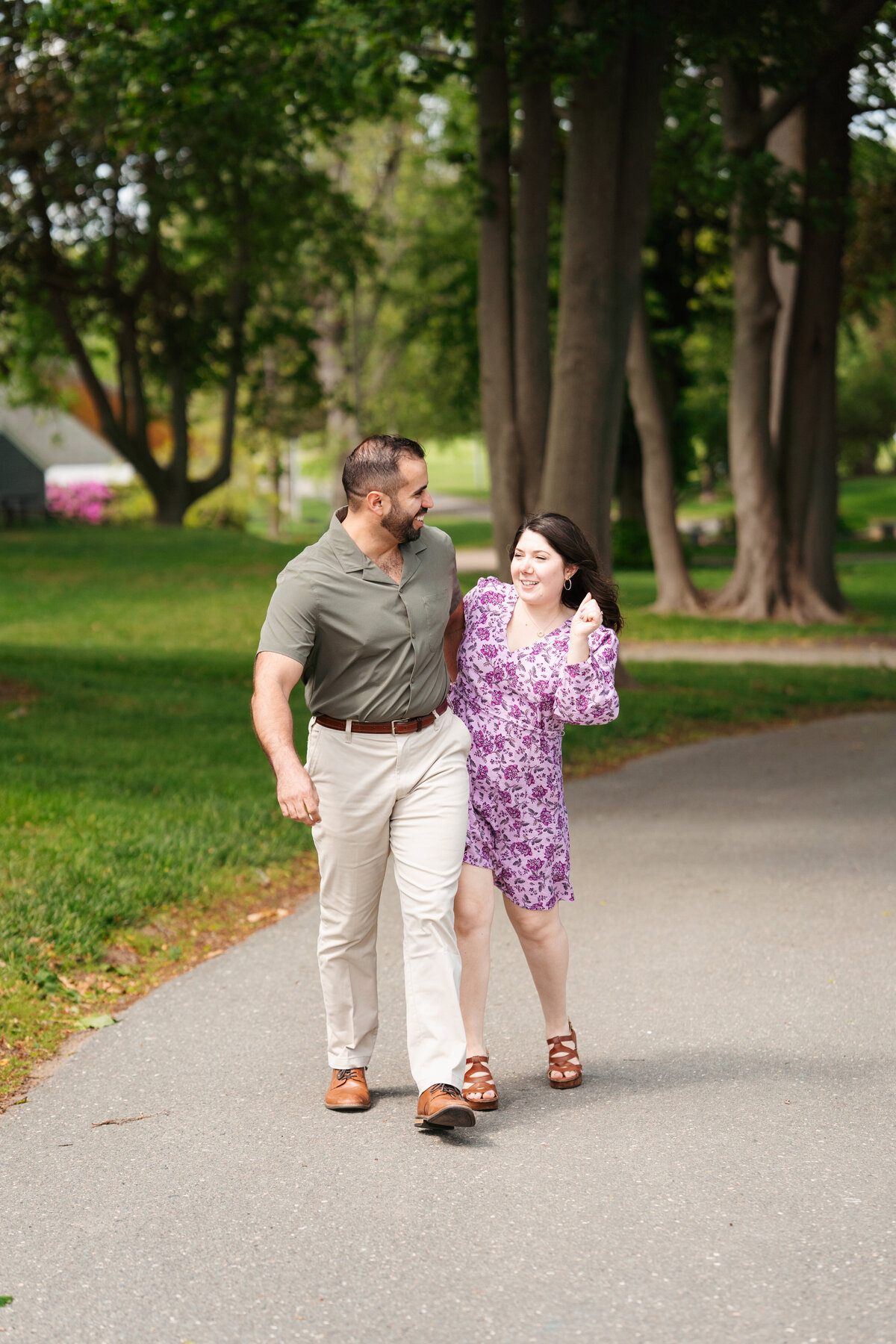 Couple walking through the rose garden at Lynch Park during their Beverly engagement session with Danielle Littles Photography