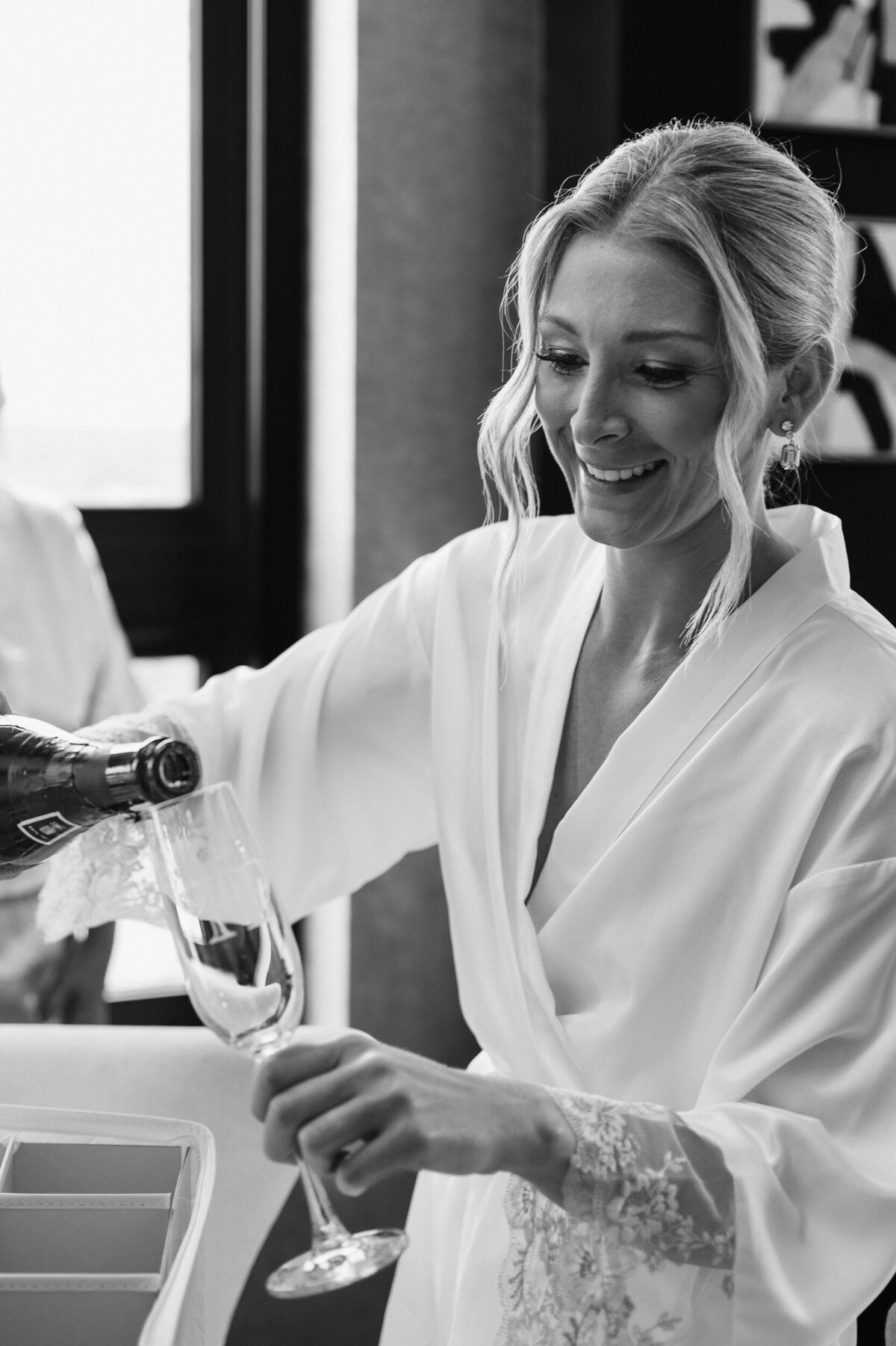 A bride pouring a glass of champagne