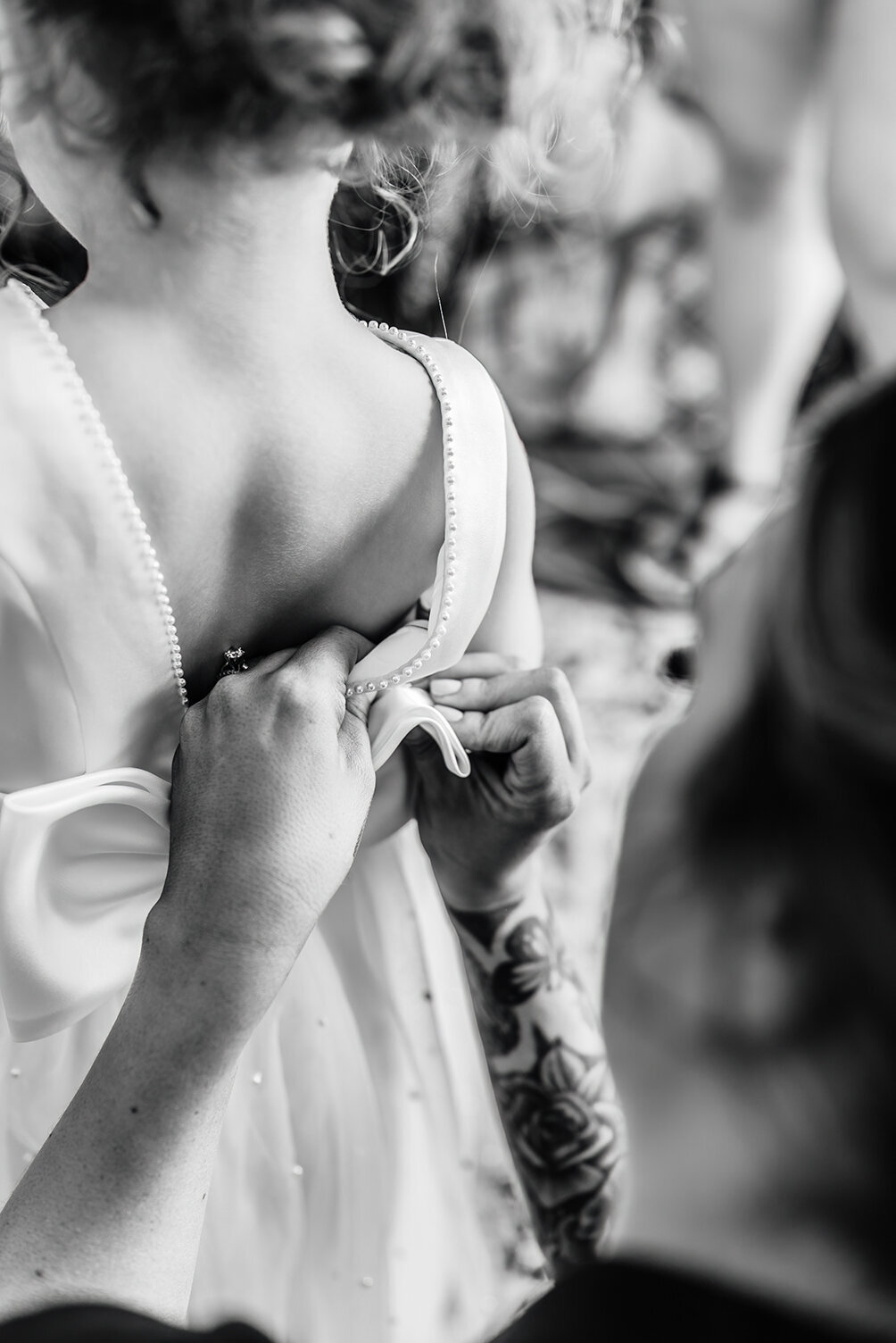 a bride dressing her 3 year old daughter