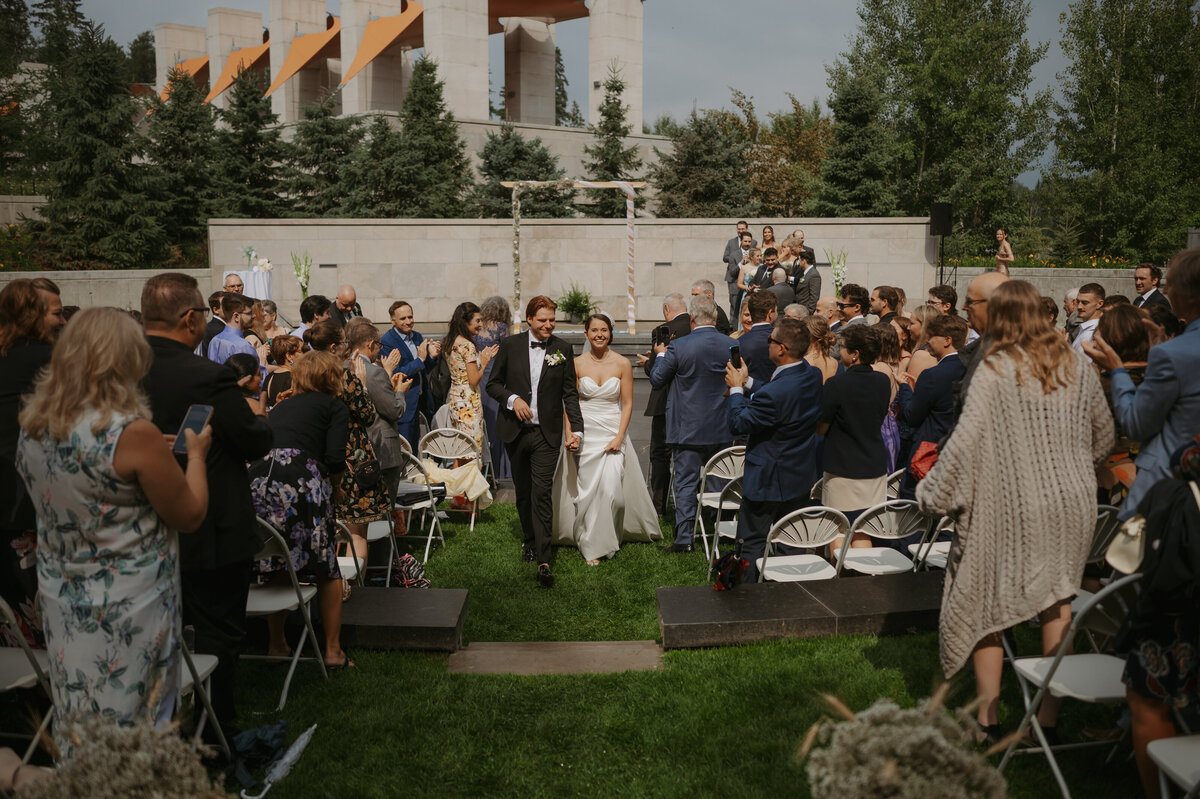 Bride and groom walking downt he aisle at u of a botanical gardens ceremony
