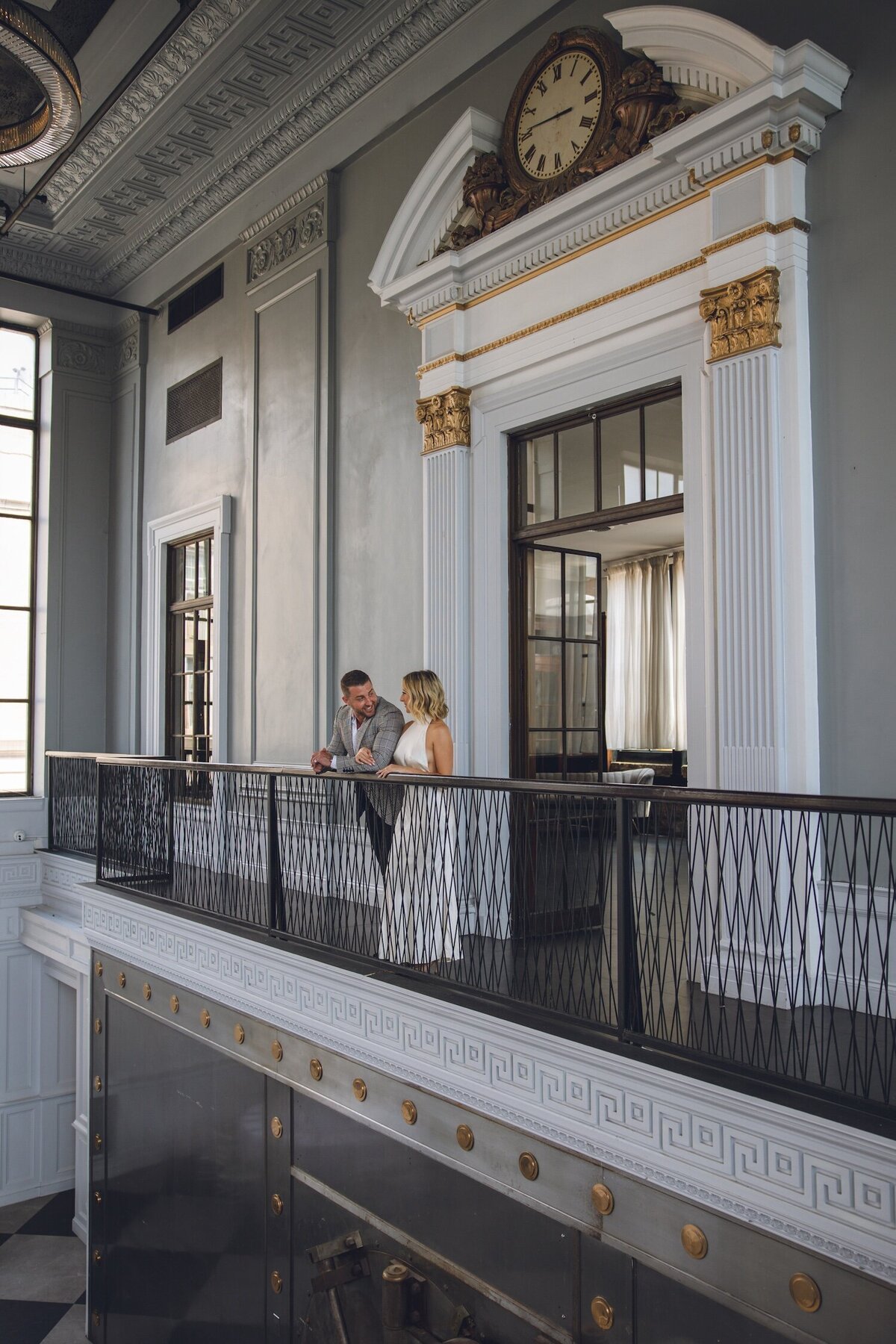Couple posing together in elegant, historic hallway at Felina.