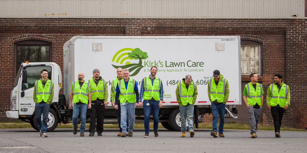 Commercial branding photo of a lawn scaping crew standing on infront of a truck