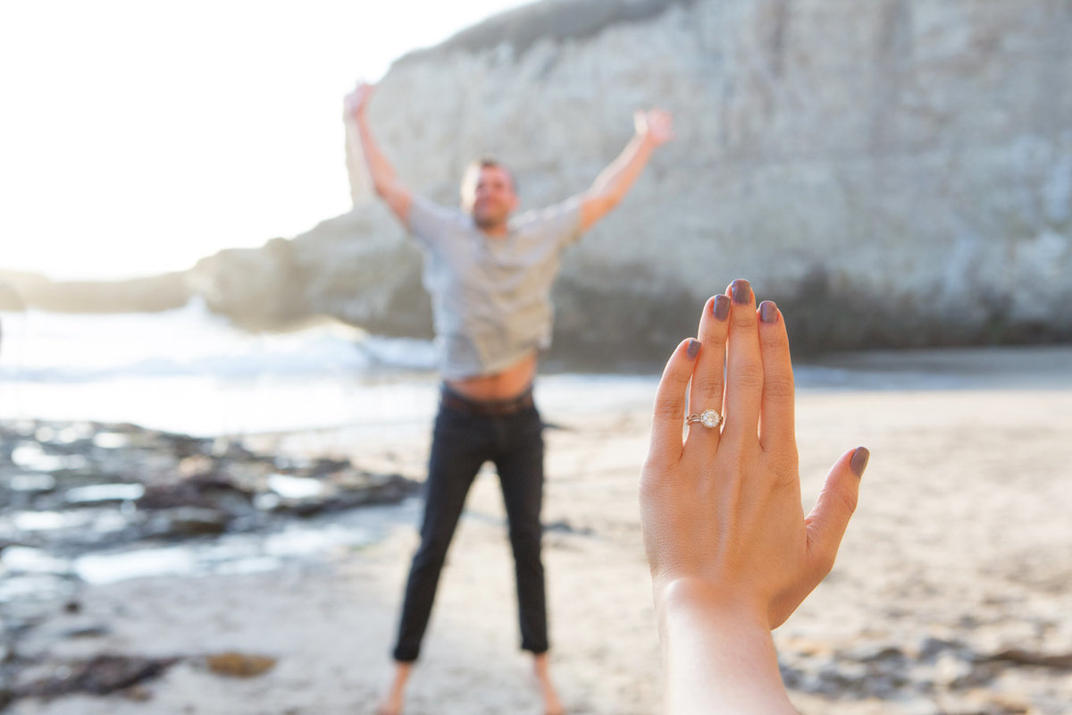 Engagement session on beach, boho theme, bride engagement ring and groom jumping, deneffe studios
