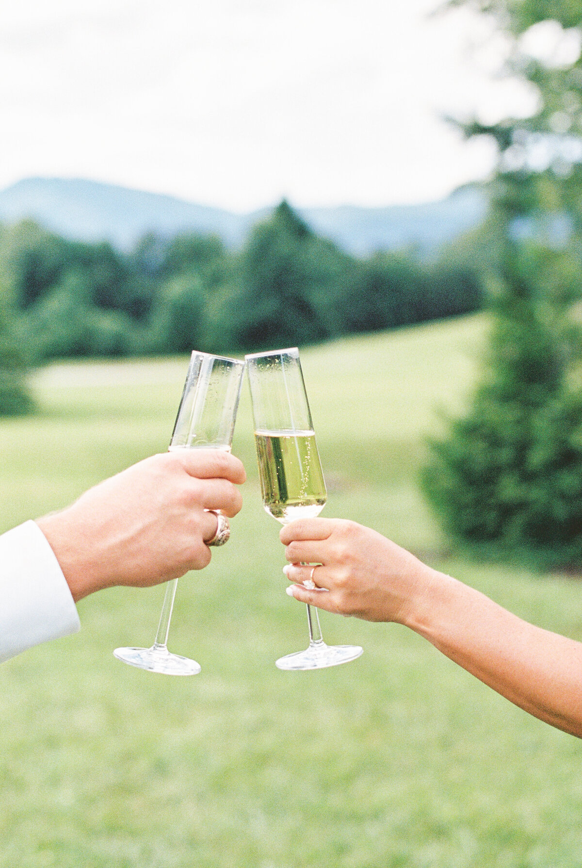 couple sharing champagne toast during  hotel domestique engagement session