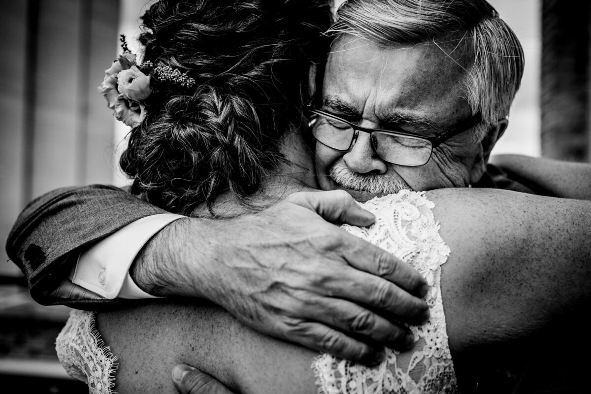 A father embraces his daughter at a Pabst Brewery wedding in Milwaukee.