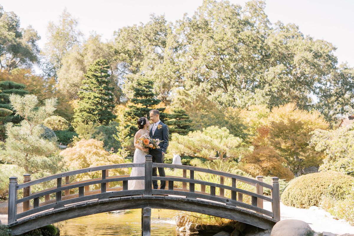 bride and groom on bridge hakone garden 