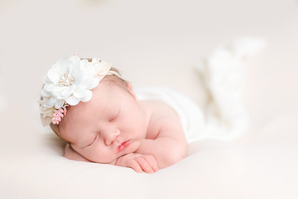 newborn girl sleeping with floral headband