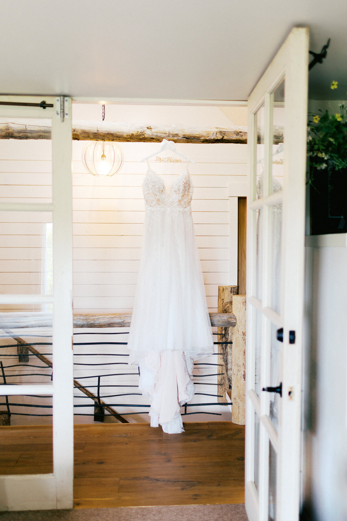 Wedding dress hanging in the rustic barn room | Minnesota wedding photographer | Toly Dzyuba Photography