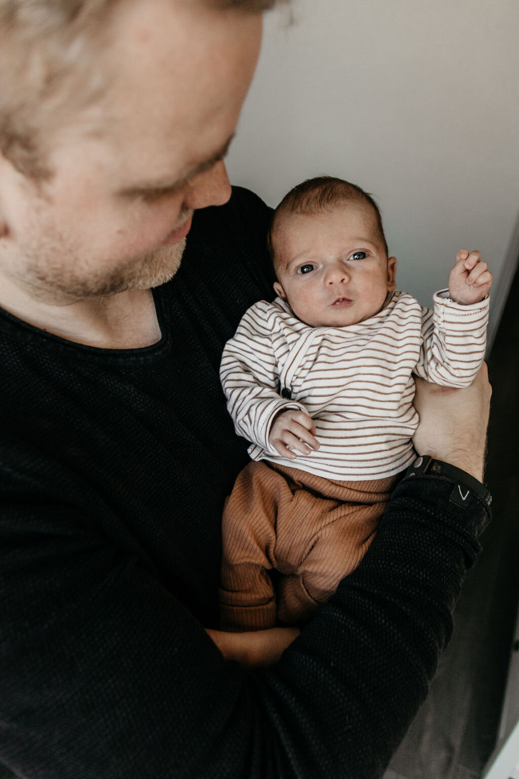 Vader samen met newborn baby tijdens een newbornshoot in Noord-Nederland