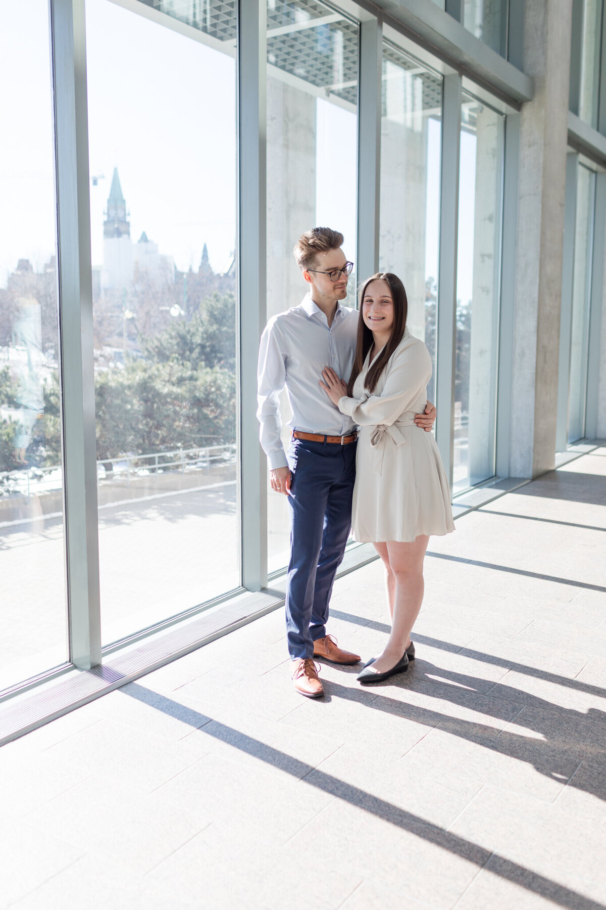 Melissa and Yannick bask in the glowing light against the backdrop of Parliament, highlighting their love in a captivating portrait.
