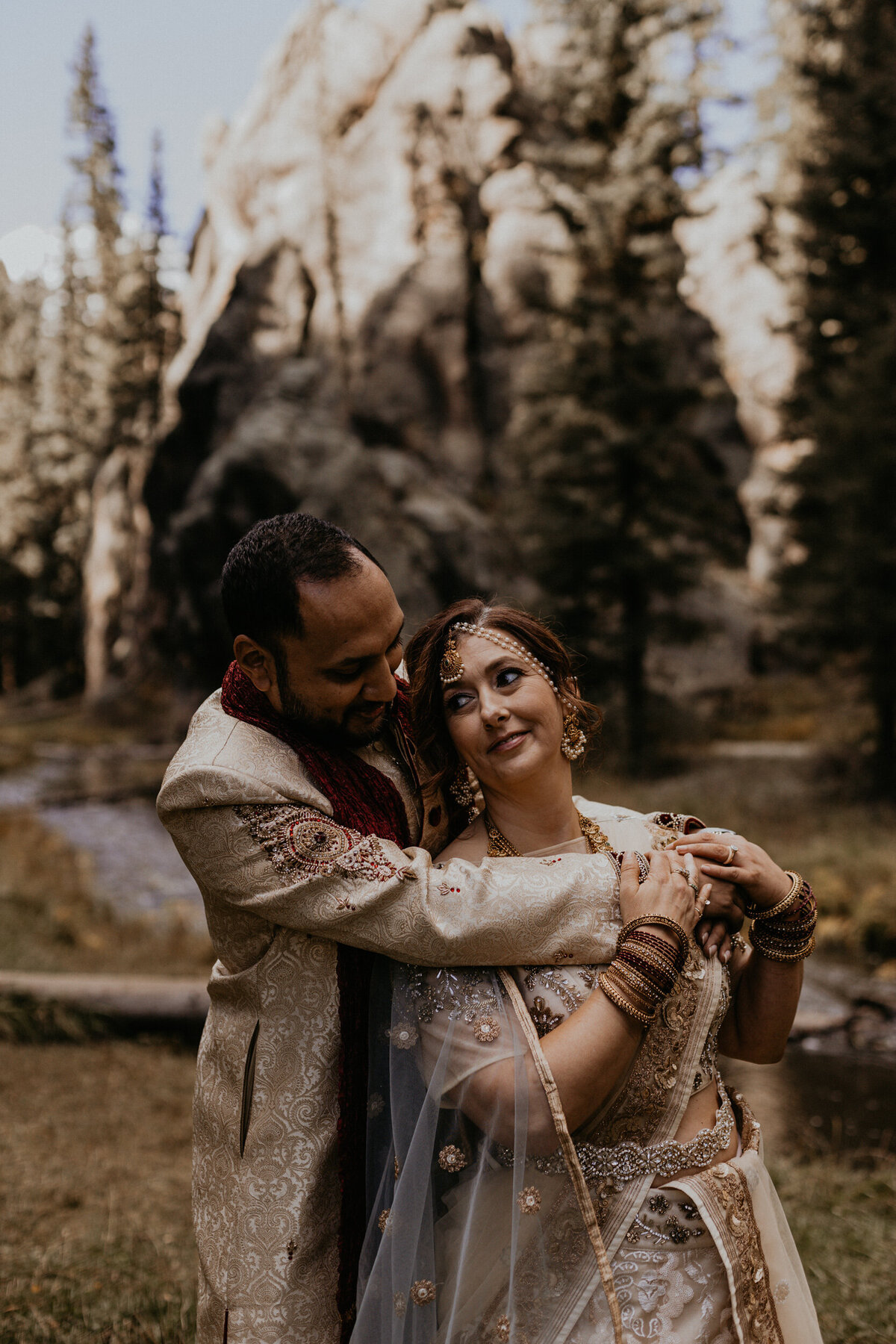 Indian groom hugging new bride from behind