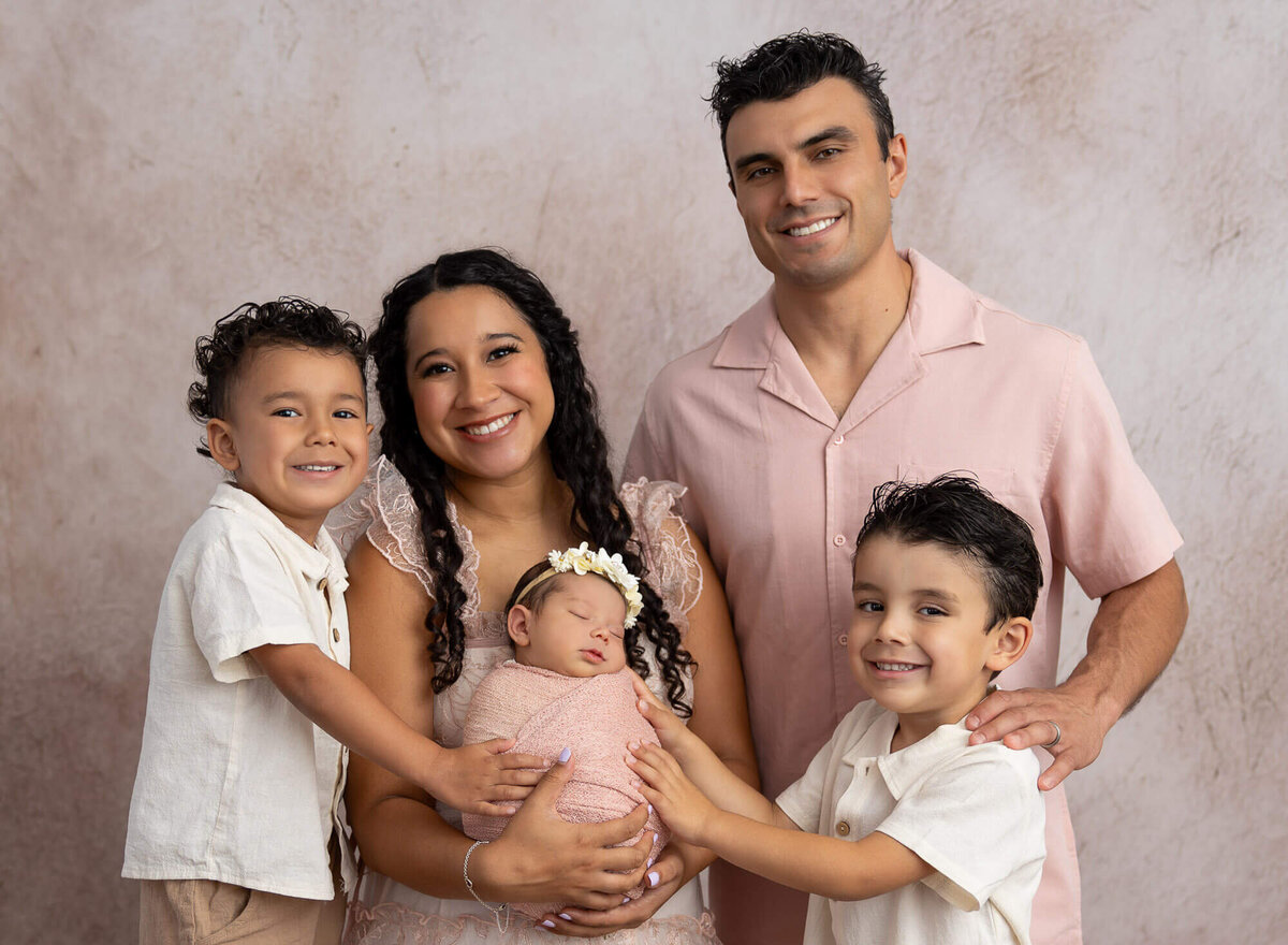 family posing around newborn for photo session
