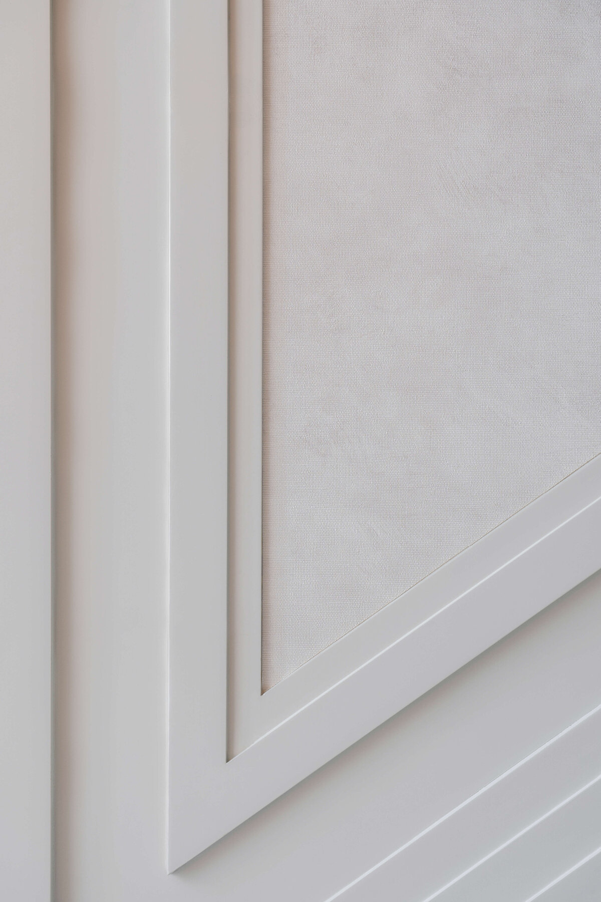 Close-up shot showing the wallpaper and  molding detail of the wall surrounding the staircase.