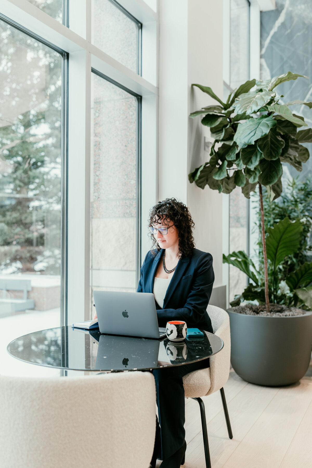 Professional branding photo of a businesswoman working at a modern workspace in Minnesota, perfect for personal brand photography near me.