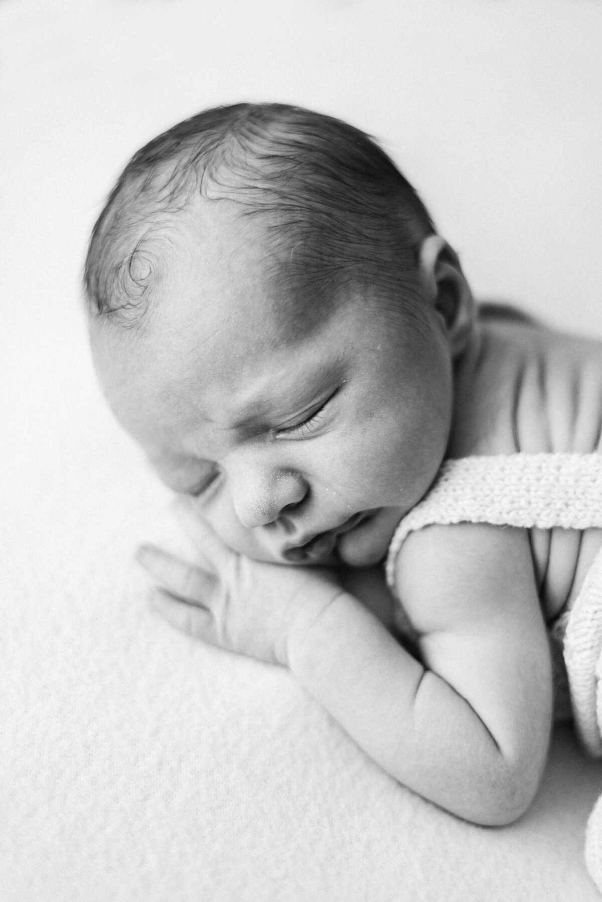 Baby boy asleep on blanket during a photoshoot in Billingshurst
