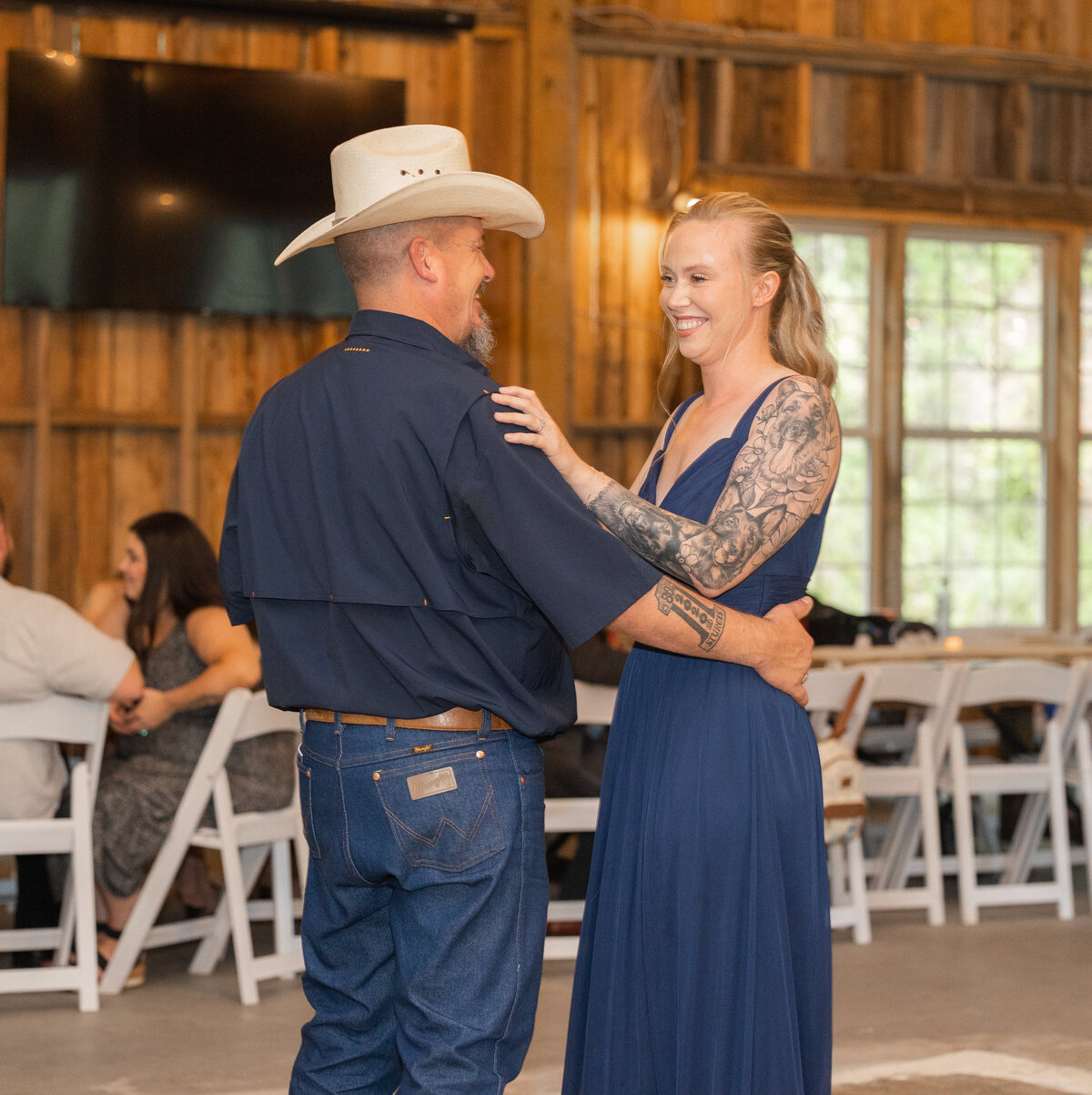 groom wearing tan cowboy hat while dancing with daughter wearing blue dress at Mountain  Willow Manor by Chattanooga wedding photographer Amanda Richardson Photography