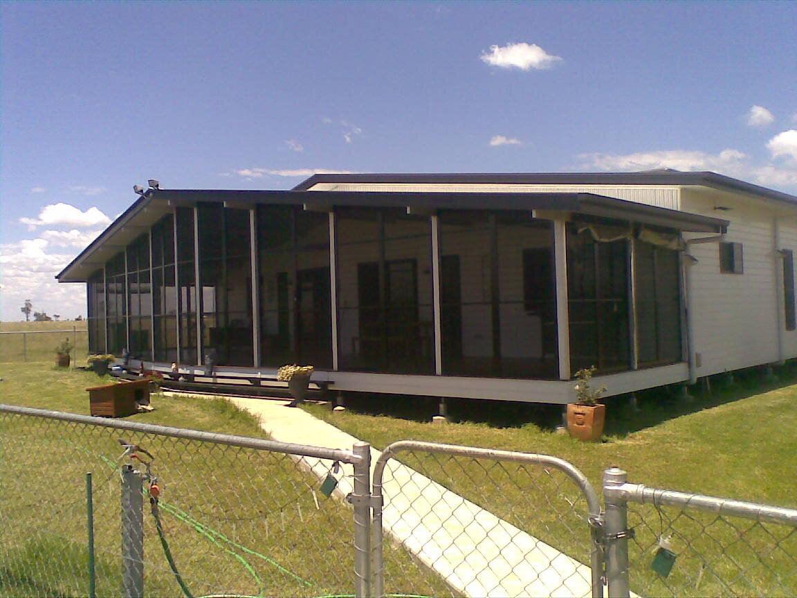 Outdoor patio with barrier screens for privacy and protection, designed for residential use.