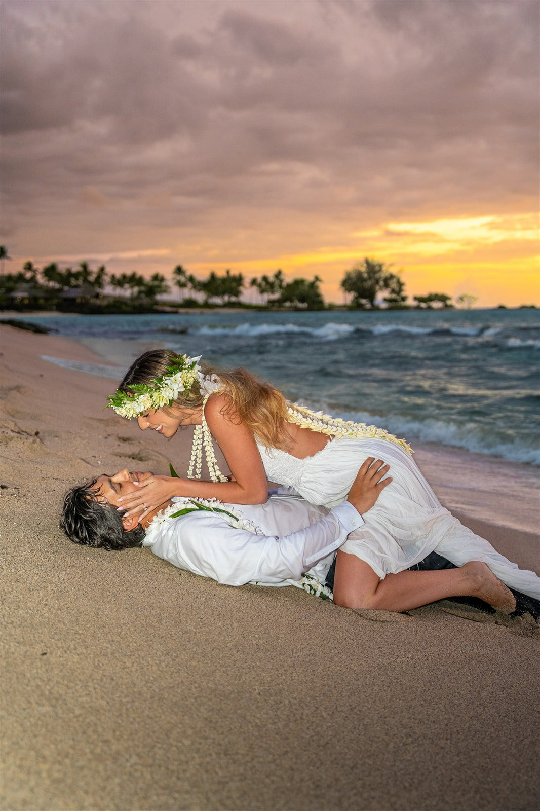 kona wedding photography with couple laying on the beach
