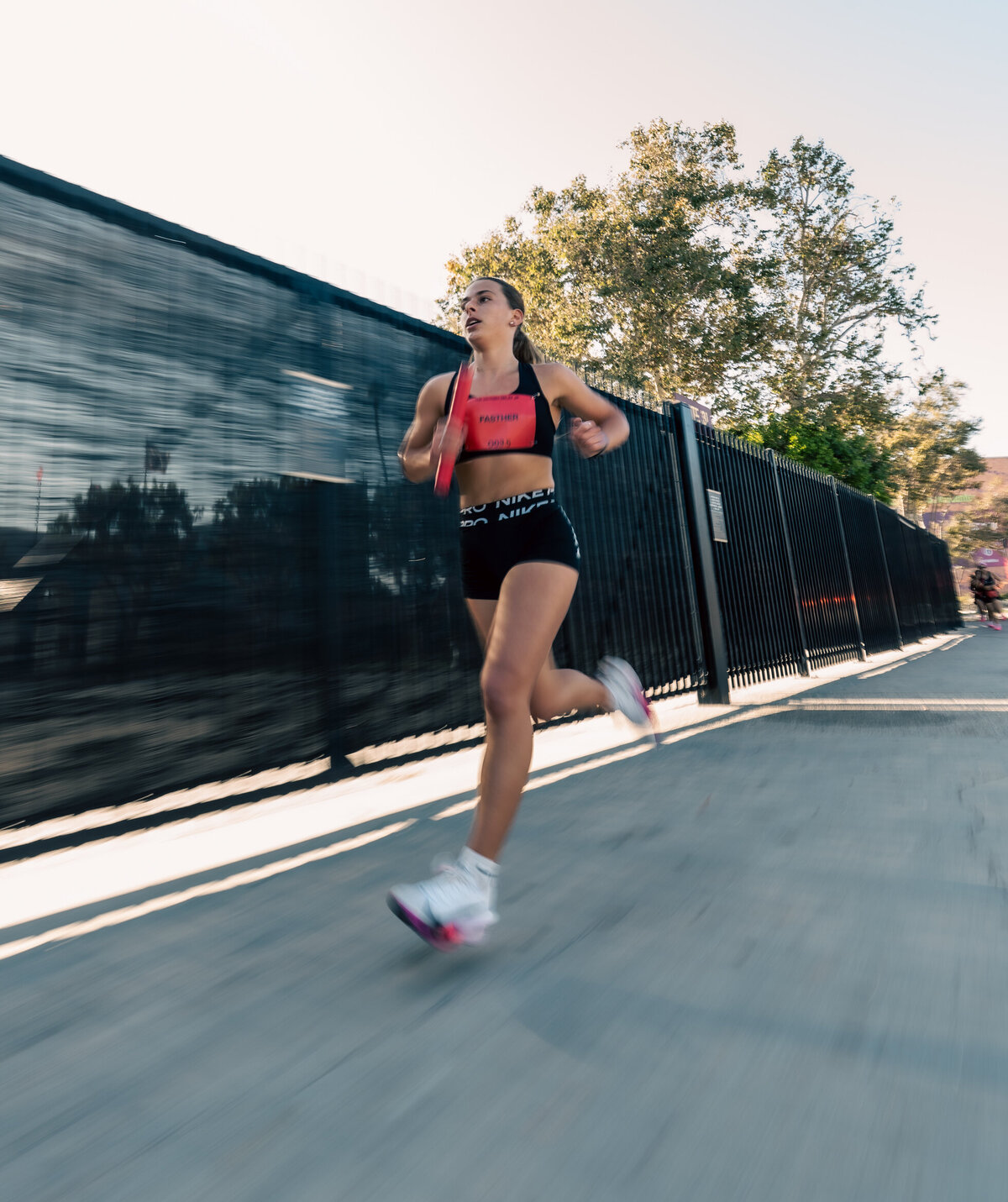 HER Sports Club member running outdoors during a training session.