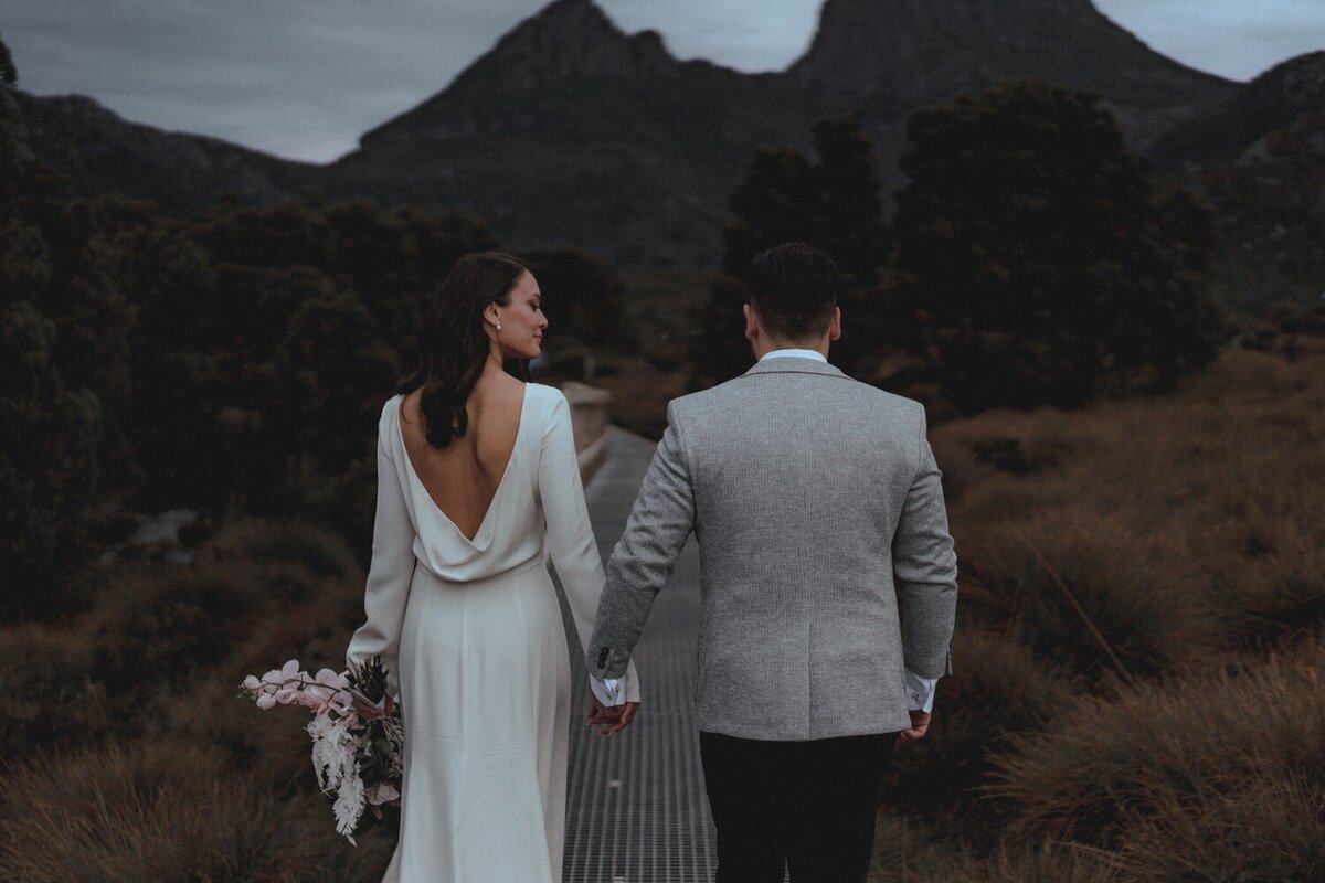 Bride and Groom standing in front of a mountain
