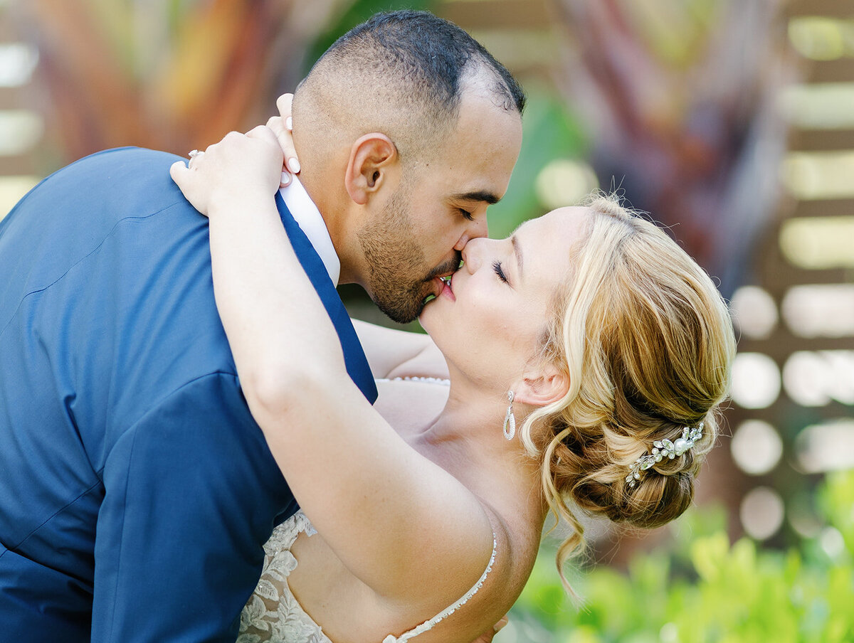 Rafael dips Kelly for a passionate kiss in a lush garden setting at La Siesta Marina Resort, Islamorada.