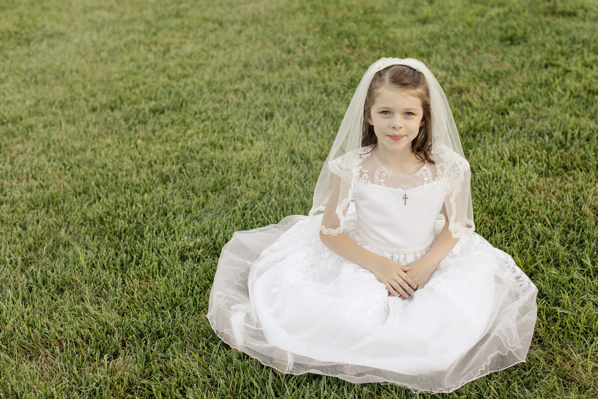 little girl in white dress in the grass