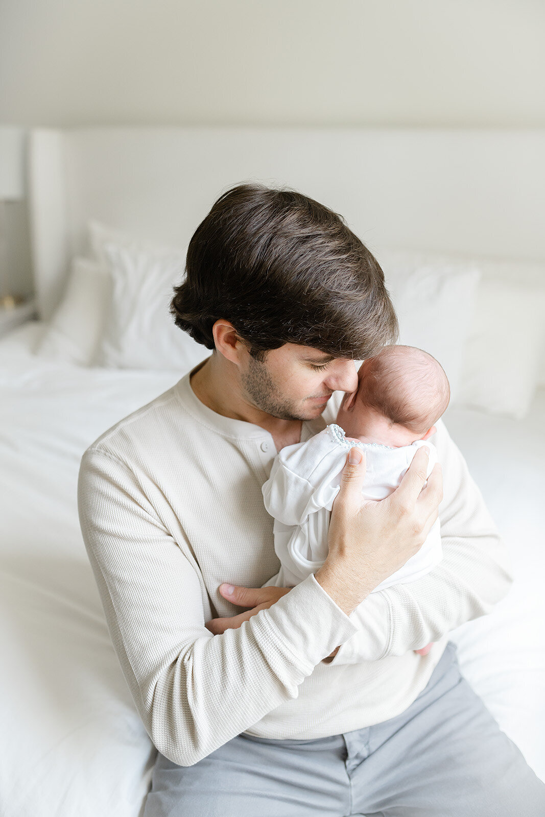 a father holding his newborn baby