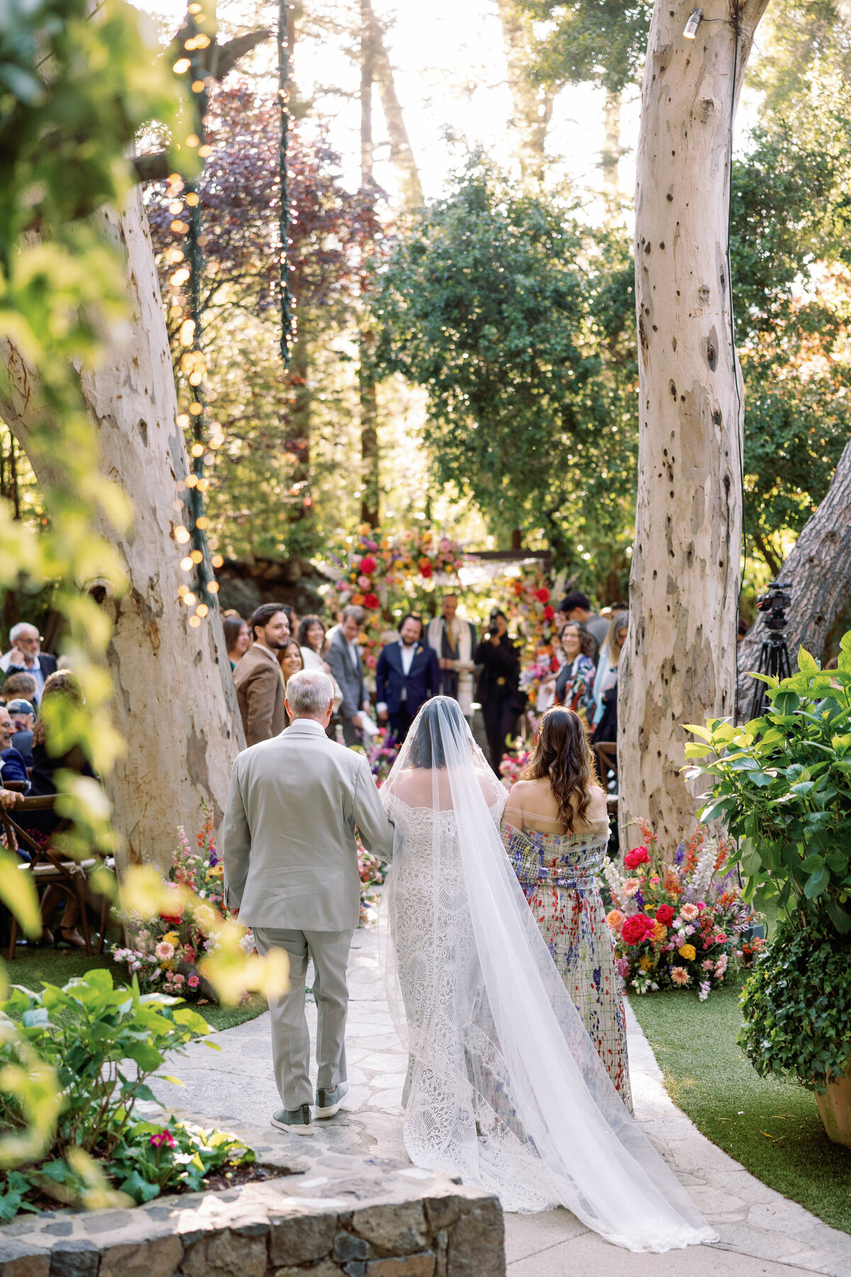 A bride walking down the aisle with her parents