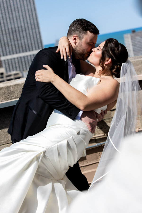 bride-groom-kiss-rooftop-intercon-hotel-chicago-HBICWeddings